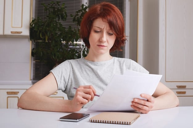 A person looking stressed and overwhelmed while staring at their bank statement, highlighting the burden of unexpected overdraft fees.