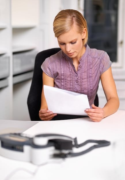 A person sitting at a desk, filling out an application form for an Income-Driven Repayment plan on their laptop. The background is a clean and organized home office, symbolizing the proactive management of their student loan debt. The image should convey a sense of empowerment and taking control of their financial situation.