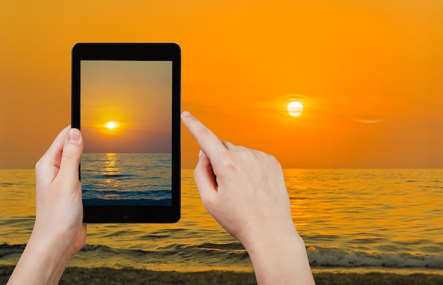 A close-up of a hand carefully selecting options on a tablet, with a background depicting a peaceful retirement scene (e.g., a couple watching a sunset on a beach).