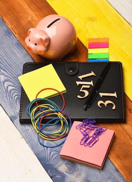 A close-up of a calculator and a family budget planner, with sticky notes highlighting childcare expenses. The image is well-lit and focuses on the numbers and financial planning aspects.