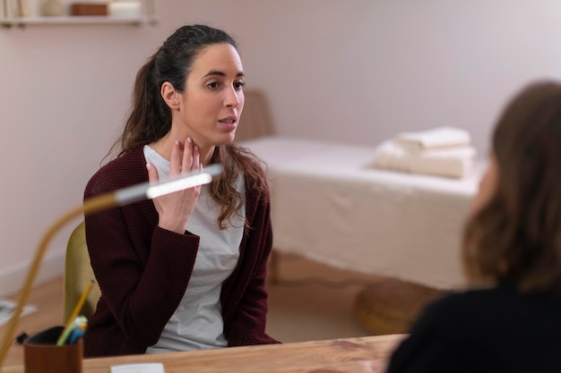 A close-up shot of a therapist in a professional office setting, actively listening and offering empathetic support to an employee. The scene conveys a sense of trust and confidentiality, highlighting the importance of the therapeutic relationship in addressing mental health concerns provided by EAPs.