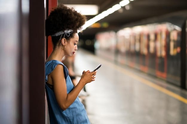 A person scanning a transit pass at a subway entrance with a digital display showing 
