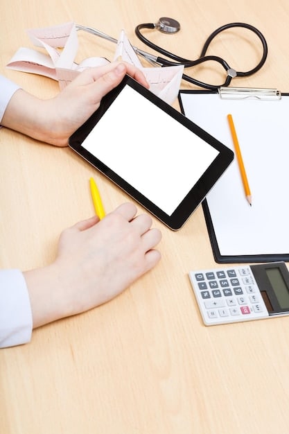A person holding a tablet, reviewing information about health insurance options and potential changes to COBRA.