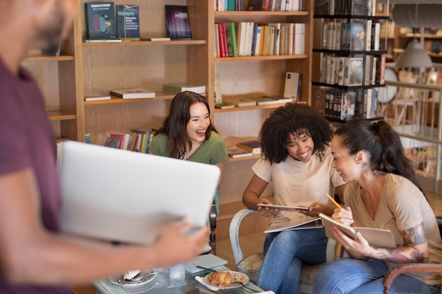 A diverse group of college students studying together in a library, highlighting the collaborative and supportive environment of higher education.