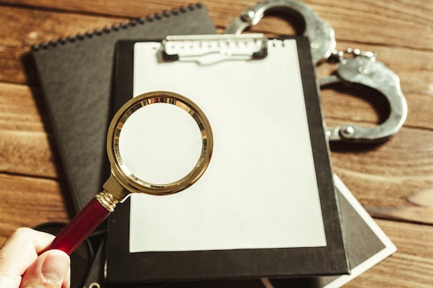 A close-up of an official document with a magnifying glass hovering over it, symbolizing a detailed review of eligibility requirements for student loan forgiveness.