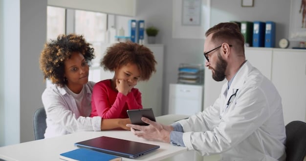 A doctor consulting with a family in a clinic, reviewing their medical records and discussing healthcare needs.