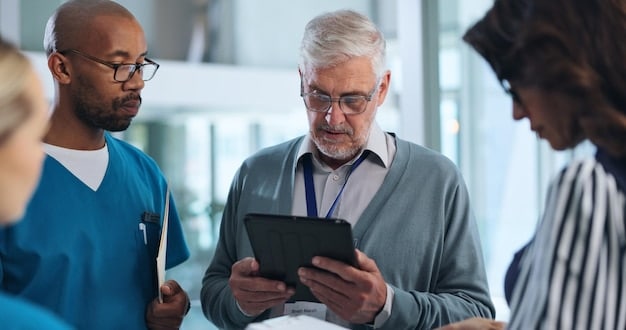 A doctor using a tablet to show a patient their health insurance plan's network of providers. The scene is modern and professional, emphasizing the importance of understanding network coverage.