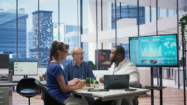 A diverse group of investors reviewing bond performance charts on laptops and tablets in a modern office setting.