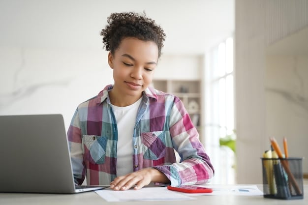 A student smiling while filling out the FAFSA form on a laptop at a desk with college brochures.